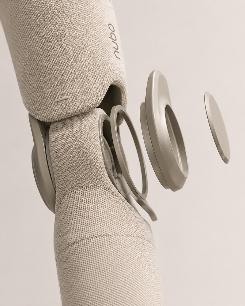 Exploded view of Nubo magnetic snap connector separating from the garment at the elbow